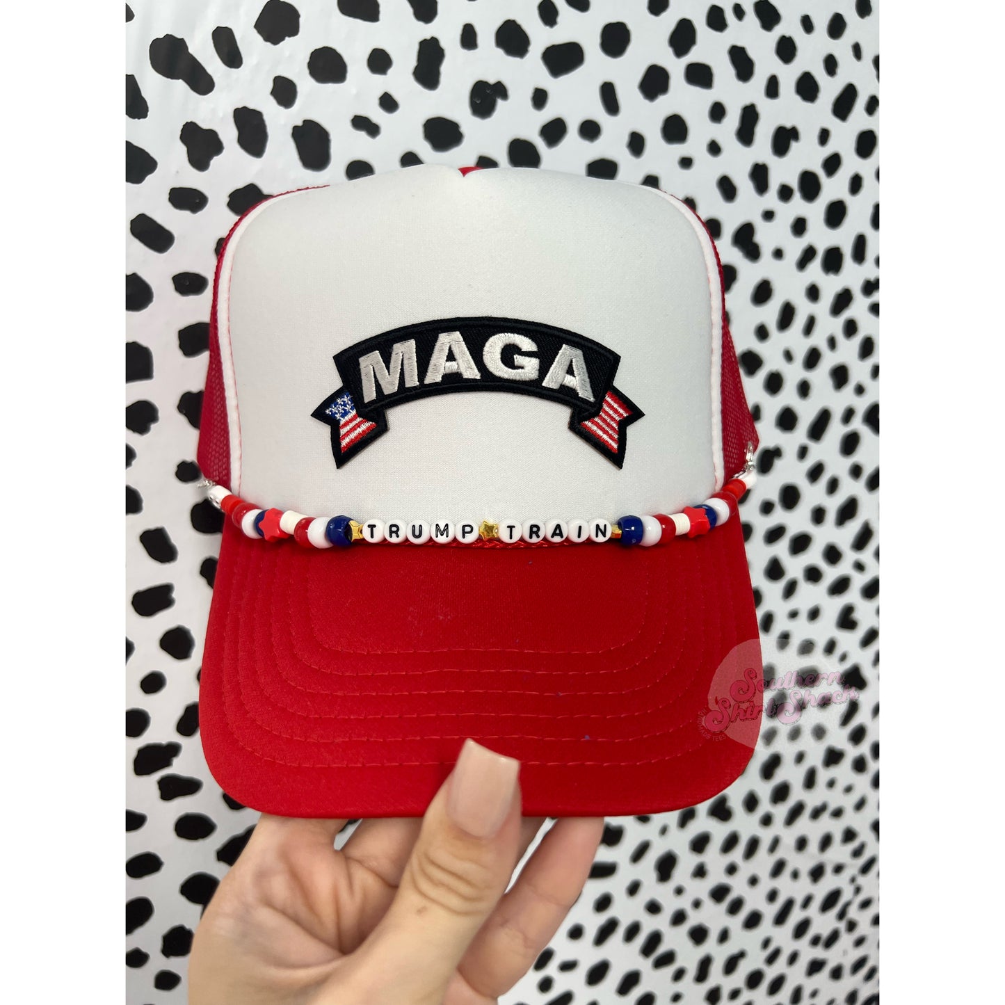 MAGA trucker hat with Trump Train hat charm